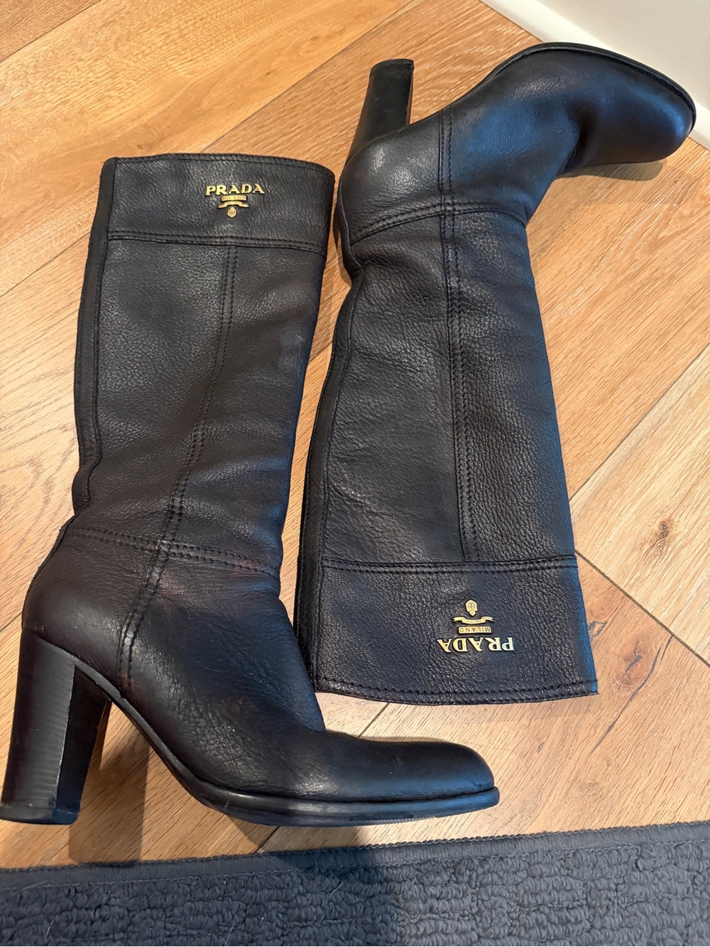 Prada Black Leather Knee-High Block Heel Boots with Gold Logo